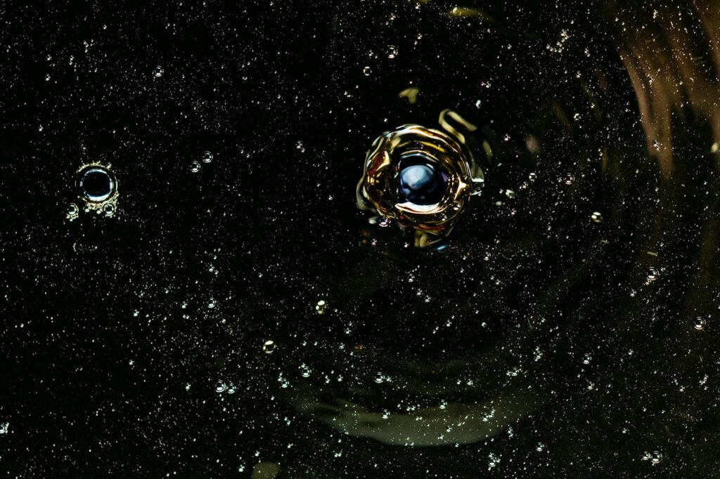 A captivating close-up of shimmering bubbles in dark liquid capturing dynamic motion and design.